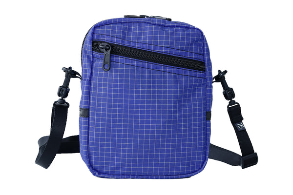 An Everyday Cubelet in Selkie Halcyon (purplish-blue with a white grid) with a front zipper.